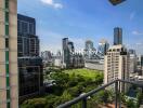 View from balcony overlooking cityscape with greenery