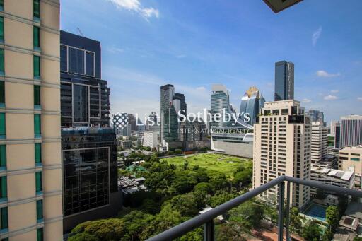 View from balcony overlooking cityscape with greenery