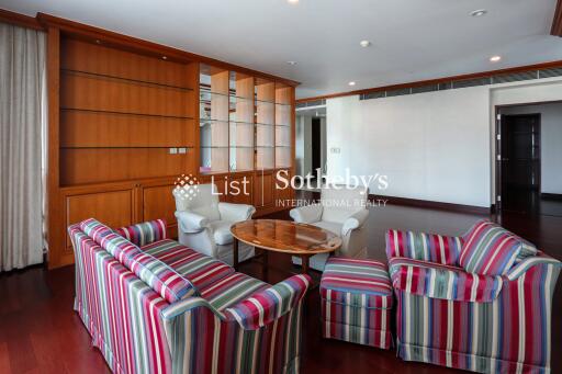 Living room with striped chairs and wooden built-in shelves