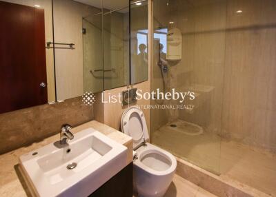 Modern bathroom with sink, toilet, and glass-enclosed shower