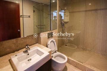 Modern bathroom with sink, toilet, and glass-enclosed shower