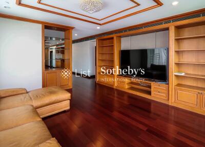 Spacious living room with wooden furniture and built-in shelves