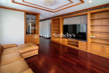 Spacious living room with wooden furniture and built-in shelves