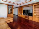 Spacious living room with wooden furniture and built-in shelves