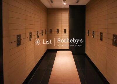 Luxury changing room with wooden lockers and dim lighting