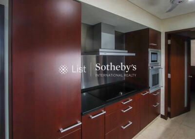 modern kitchen with dark wood cabinets and built-in appliances