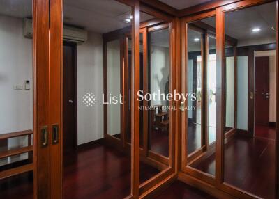 Spacious walk-in closet with mirrored sliding doors