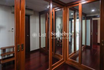 Spacious walk-in closet with mirrored sliding doors