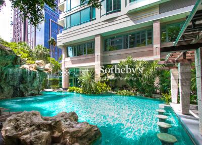 Modern building with beautiful outdoor pool and lush greenery