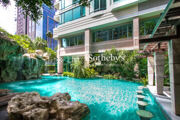 Modern building with beautiful outdoor pool and lush greenery