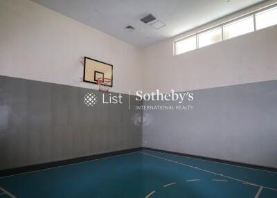 Indoor basketball court with hoop and natural light