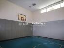 Indoor basketball court with hoop and natural light