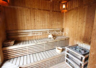 Wooden sauna interior with bench and heater