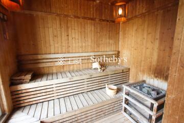 Wooden sauna interior with bench and heater