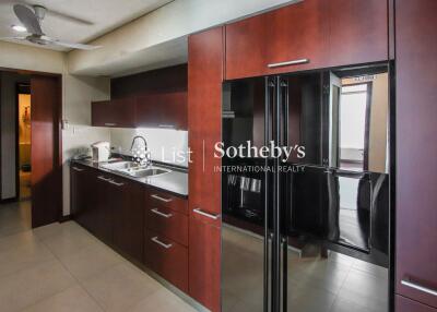 Modern kitchen with dark wood cabinets and stainless steel appliances