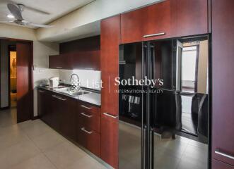 Modern kitchen with dark wood cabinets and stainless steel appliances