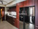 Modern kitchen with dark wood cabinets and stainless steel appliances