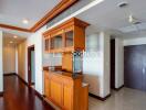 Modern kitchen area with wooden cabinets and built-in appliances