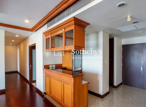 Modern kitchen area with wooden cabinets and built-in appliances