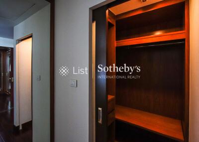 Spacious walk-in closet with wooden shelving and hanging space