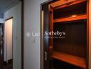 Spacious walk-in closet with wooden shelving and hanging space