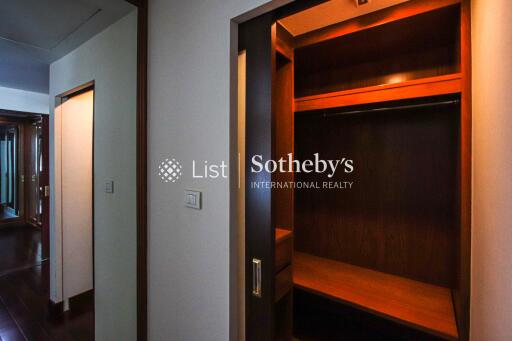 Spacious walk-in closet with wooden shelving and hanging space