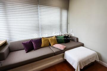 Cozy living room with a sectional sofa, colorful cushions, and a coffee table.