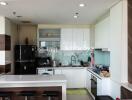 Modern kitchen with white cabinetry and built-in appliances