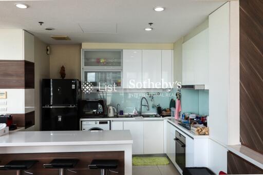 Modern kitchen with white cabinetry and built-in appliances