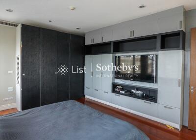 modern bedroom with built-in furniture and flat-screen TV