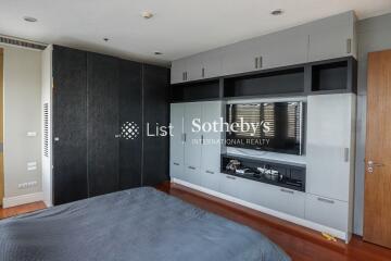 modern bedroom with built-in furniture and flat-screen TV