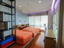 Cozy bedroom with orange bed covers and natural light