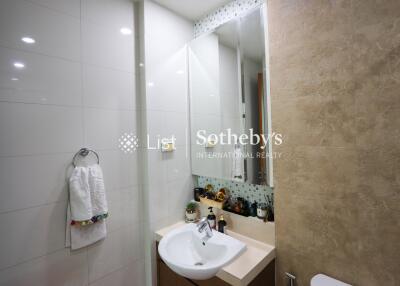 Modern bathroom with a large mirror, sink, and towel holder