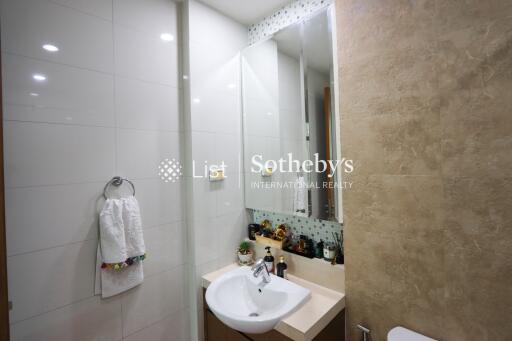 Modern bathroom with a large mirror, sink, and towel holder