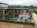 Exterior view of a modern two-story house with a pool