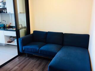 Living room with blue L-shaped sofa