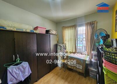 Small bedroom with wardrobe, window and various items.