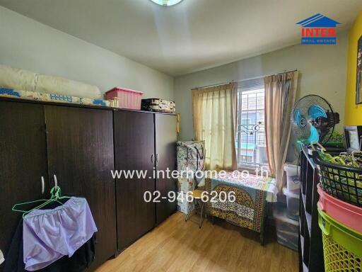 Small bedroom with wardrobe, window and various items.