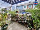 A well-maintained outdoor patio area with various potted plants and a view of the neighborhood