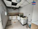 A kitchen in need of renovation with tiled backsplash and countertop space.