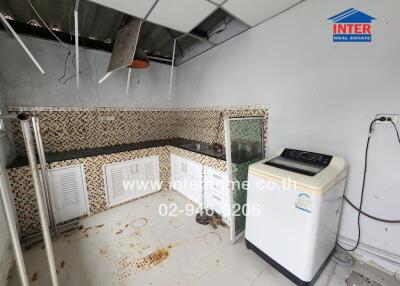 Home kitchen with appliances and tile backsplash