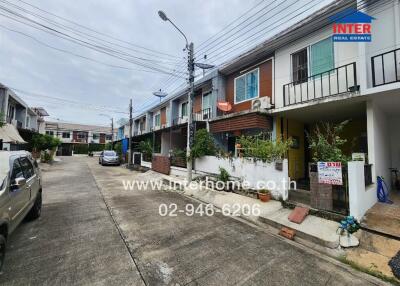 Exterior view of townhouse complex with multiple units and driveway