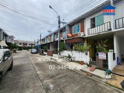 Exterior view of townhouse complex with multiple units and driveway