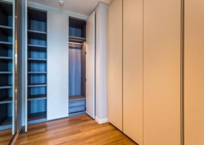 Spacious bedroom wardrobe with wooden flooring