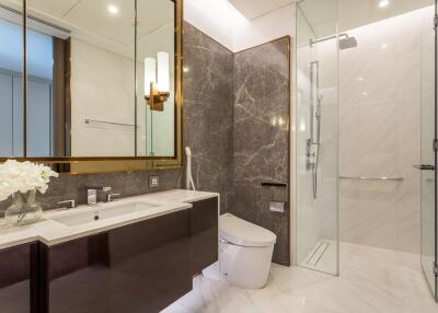 Modern bathroom with glass shower and marble accents