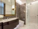 Modern bathroom with glass shower and marble accents