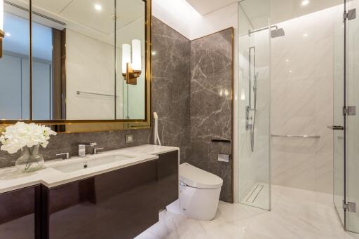 Modern bathroom with glass shower and marble accents