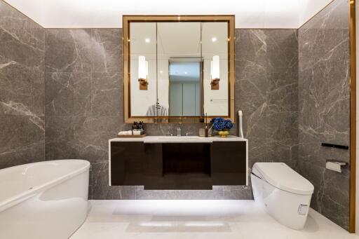 Modern bathroom with marble walls and sleek fixtures