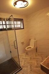 Bathroom with glass shower enclosure and modern lighting