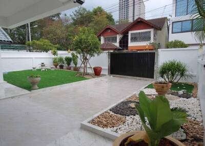 Spacious backyard with garden and paved area